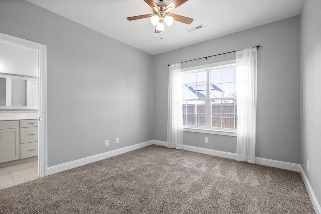 unfurnished room with ceiling fan and light colored carpet