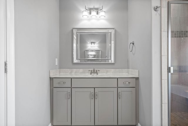 bathroom with walk in shower and vanity