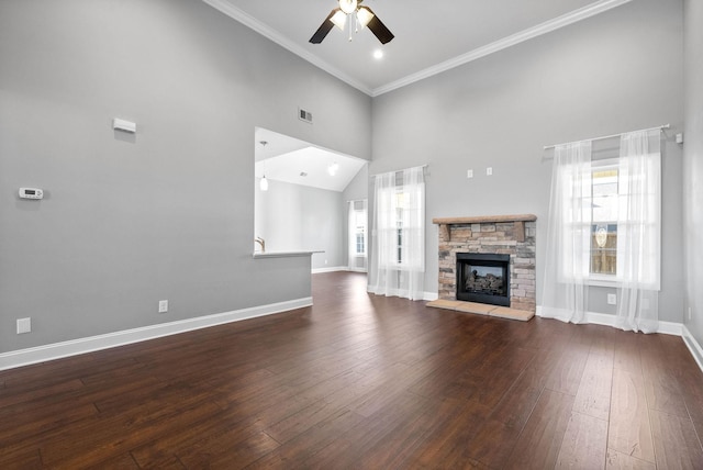 unfurnished living room with ceiling fan, dark hardwood / wood-style flooring, crown molding, and a fireplace