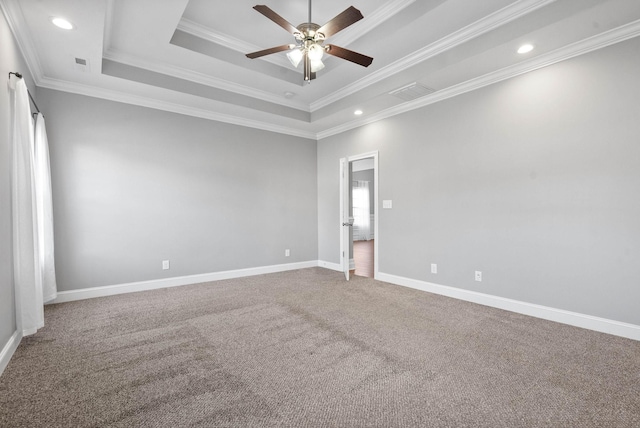 unfurnished room featuring ceiling fan, ornamental molding, carpet, and a raised ceiling