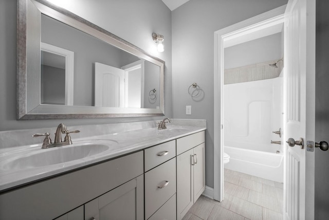 full bathroom with toilet, vanity, and  shower combination