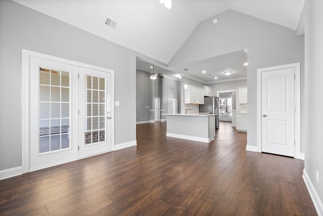 unfurnished living room with vaulted ceiling, ceiling fan, dark wood-type flooring, and sink