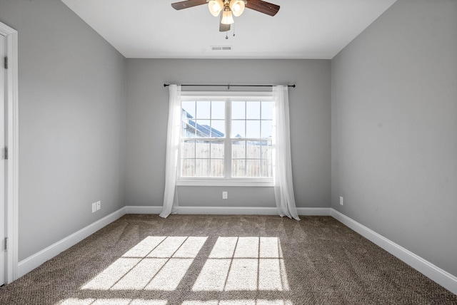 empty room with ceiling fan and carpet floors