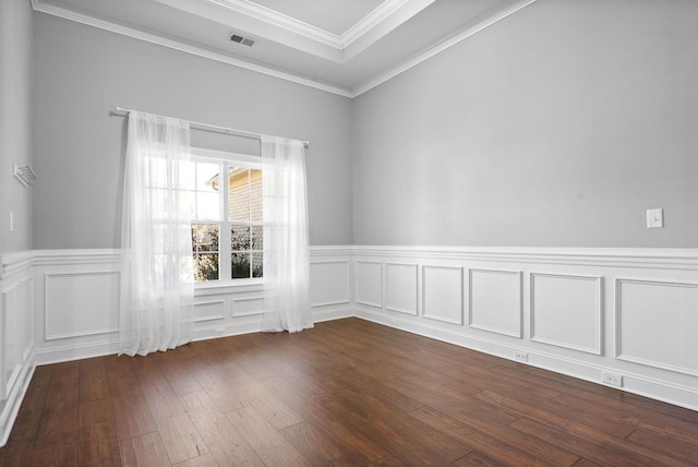 spare room featuring dark hardwood / wood-style floors and crown molding