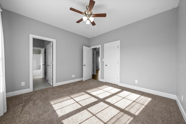 unfurnished bedroom with carpet floors, connected bathroom, a closet, and ceiling fan