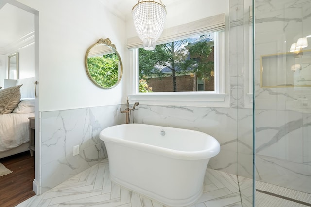 bathroom with separate shower and tub, crown molding, plenty of natural light, and a notable chandelier