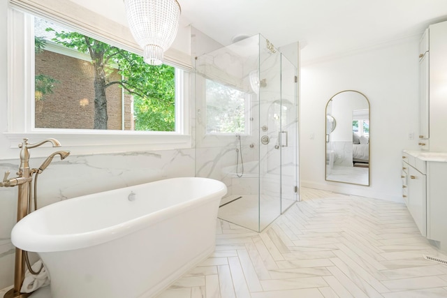 bathroom featuring a chandelier, separate shower and tub, and vanity