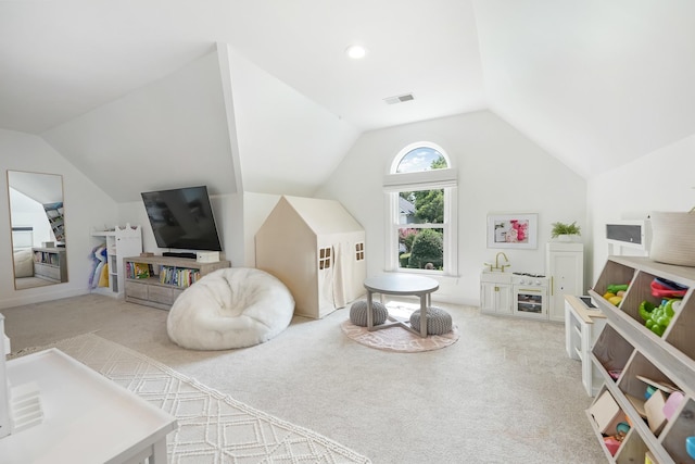 recreation room featuring vaulted ceiling and light colored carpet