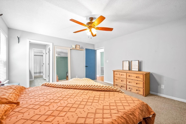 bedroom with a textured ceiling, ceiling fan, and carpet flooring