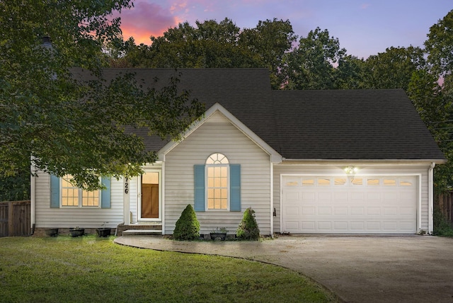 view of front of house with a yard and a garage