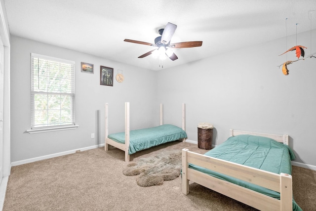 bedroom with ceiling fan and carpet flooring