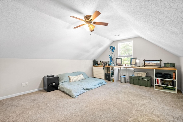 carpeted bedroom with ceiling fan, a textured ceiling, and lofted ceiling