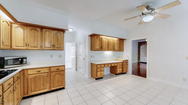 kitchen featuring ceiling fan, light tile patterned floors, and crown molding