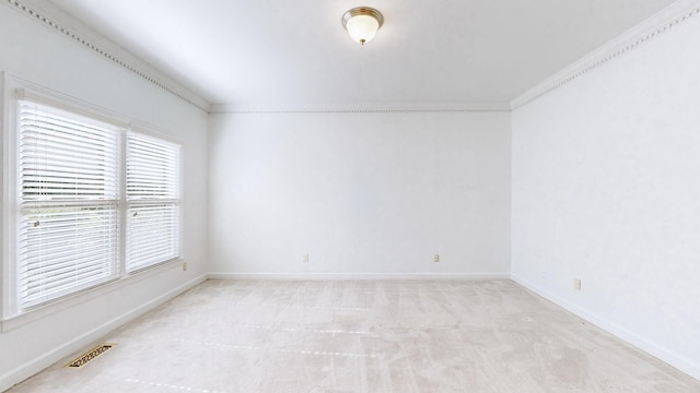 unfurnished room with light colored carpet and crown molding