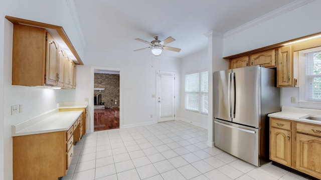 kitchen with ceiling fan, stainless steel fridge, plenty of natural light, and crown molding