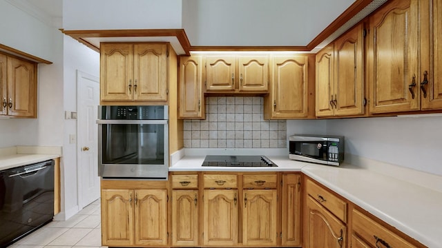 kitchen featuring light tile patterned floors, decorative backsplash, and black appliances