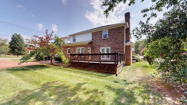 rear view of property with a deck and a yard