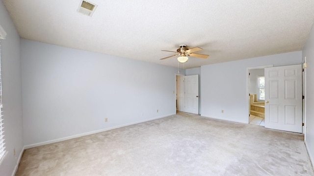 empty room with ceiling fan and light carpet