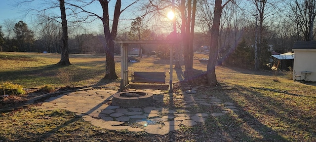 view of yard featuring an outdoor fire pit and a patio