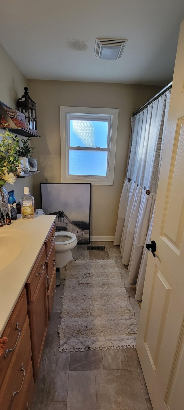 bathroom featuring toilet and vanity