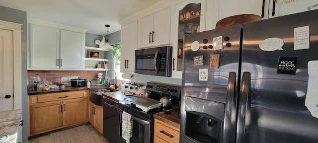 kitchen with decorative light fixtures, backsplash, butcher block countertops, white cabinetry, and stainless steel appliances