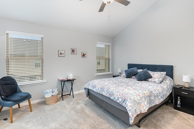 carpeted bedroom with ceiling fan, multiple windows, and lofted ceiling