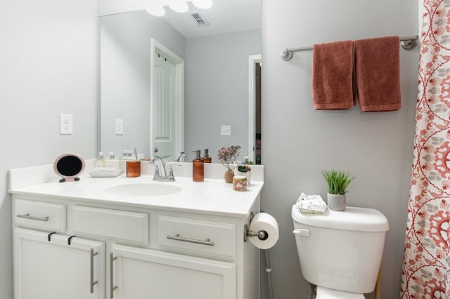 bathroom with toilet and vanity