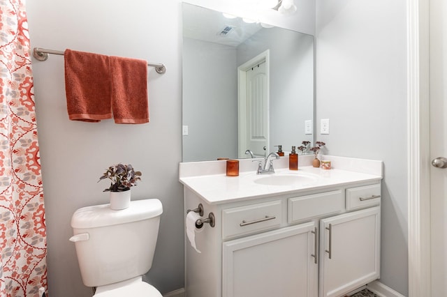 bathroom featuring toilet and vanity