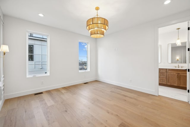 interior space with sink and light hardwood / wood-style flooring