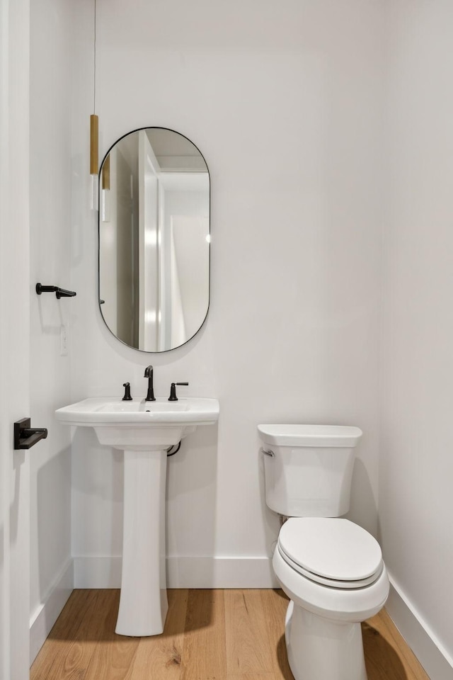 bathroom featuring hardwood / wood-style floors and toilet