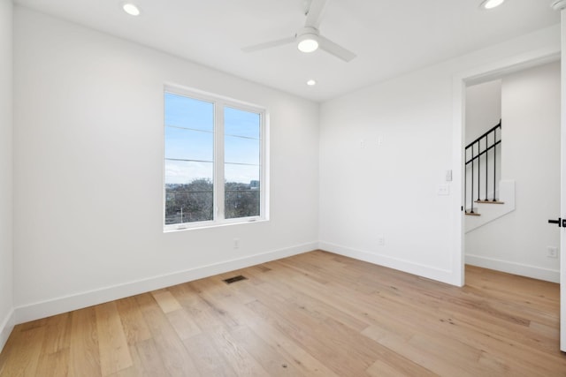 unfurnished room with ceiling fan and light hardwood / wood-style flooring