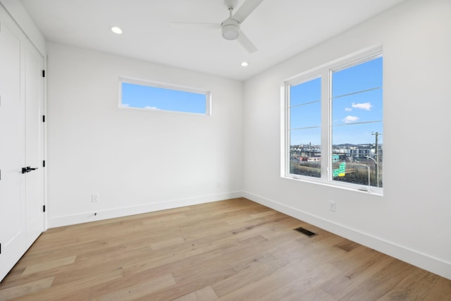 spare room with ceiling fan and light hardwood / wood-style flooring