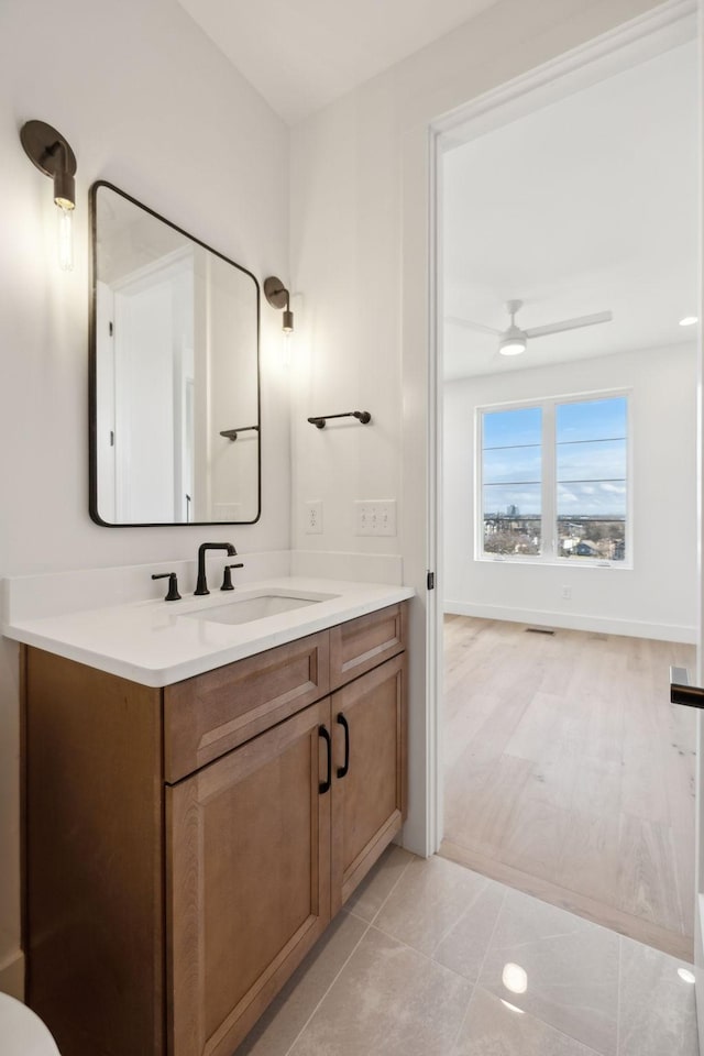 bathroom featuring tile patterned floors, ceiling fan, and vanity