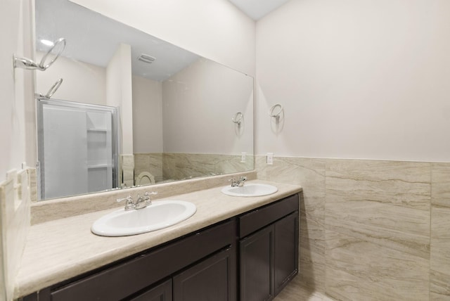 bathroom with an enclosed shower and vanity