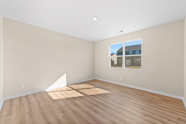 unfurnished room with light hardwood / wood-style floors