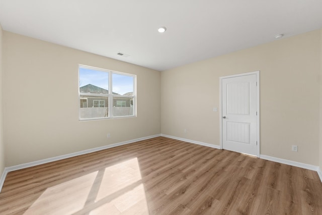 unfurnished room with light wood-type flooring