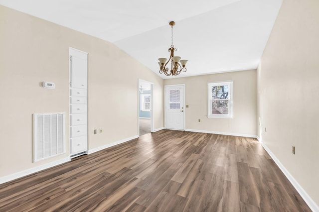 foyer featuring a chandelier, dark hardwood / wood-style floors, and lofted ceiling