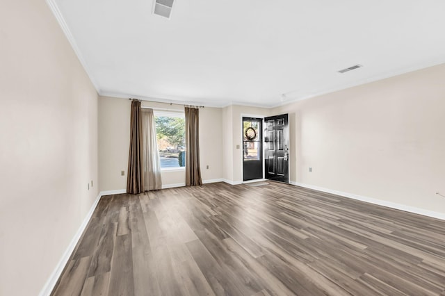 unfurnished room with ornamental molding and hardwood / wood-style floors