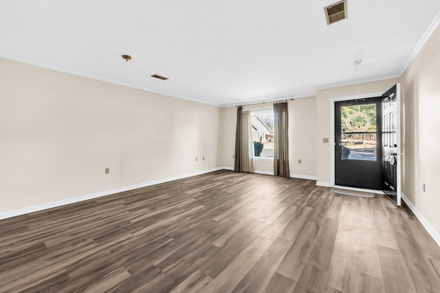 spare room with wood-type flooring and ornamental molding