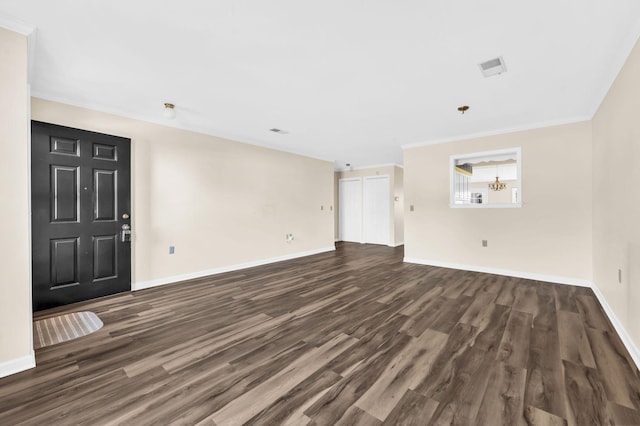 unfurnished living room with ornamental molding and dark hardwood / wood-style floors