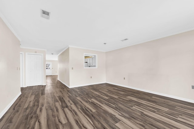 unfurnished living room featuring ornamental molding and dark hardwood / wood-style floors