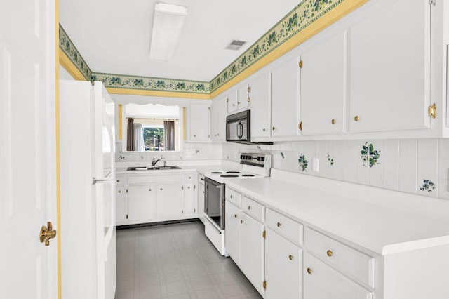 kitchen with sink, white appliances, tasteful backsplash, and white cabinets