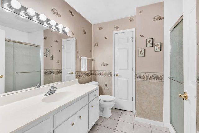 bathroom with vanity, toilet, an enclosed shower, and tile patterned flooring