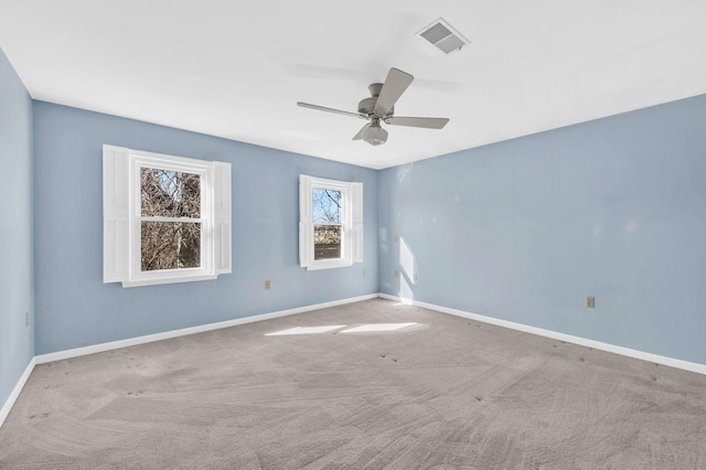 carpeted spare room with ceiling fan