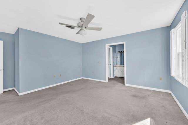 spare room featuring ceiling fan, a healthy amount of sunlight, and carpet floors