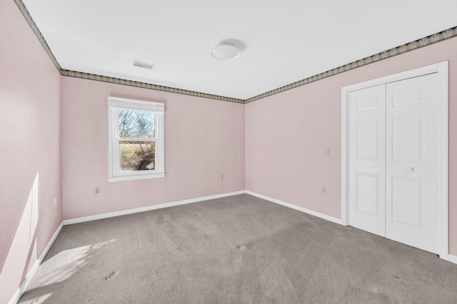 unfurnished bedroom with a closet and carpet flooring