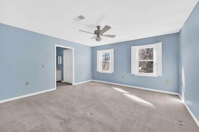 empty room with ceiling fan and light colored carpet