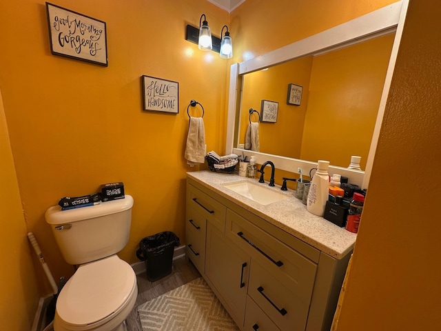 bathroom featuring vanity and toilet