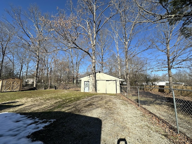 view of yard featuring an outbuilding, fence, and dirt driveway