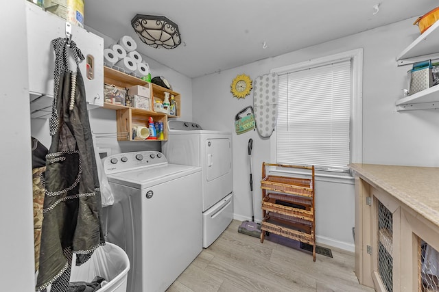 laundry area featuring separate washer and dryer and light wood-type flooring